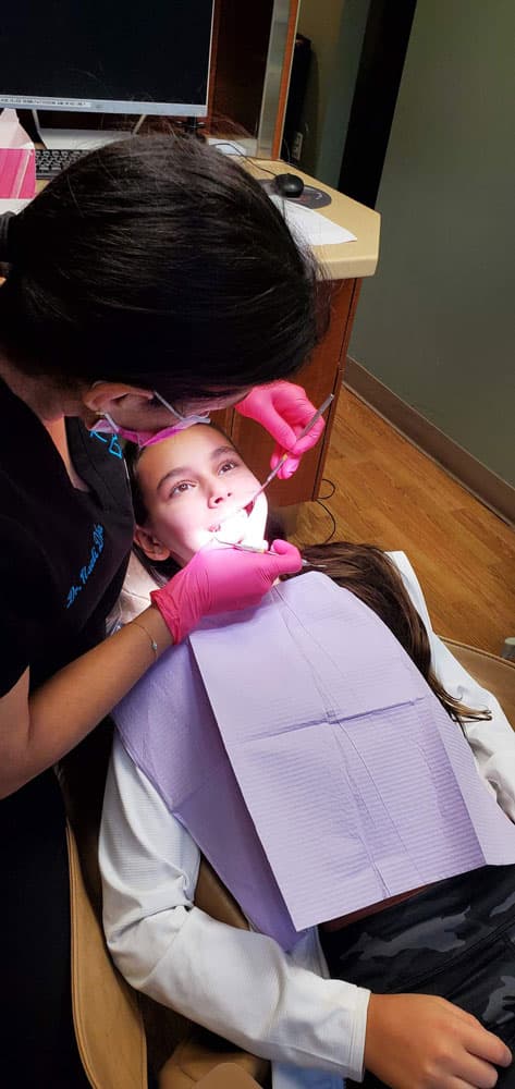 A ToothDocs clinician caring for a child patient in the Roslyn operatory